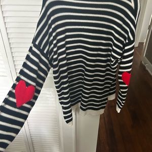 Black and white striped sweater with heart elbow patches
